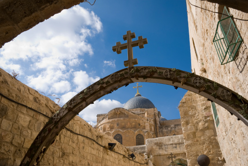 A cross atop an arch at the Holy Sepulchre church in Jerusalem's Old City