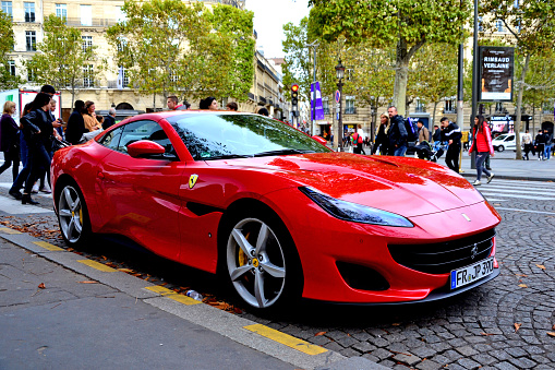 Paris, France - October 24th 2019 : red Ferrari Portofino parked on the Champs Elysees. This model is one of the last of Ferrari, and is producted since 2017.