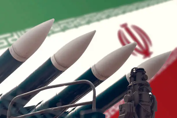 Photo of Cruise missiles on the background of the flag of Iran. The concept of a military conflict in the Persian Gulf.