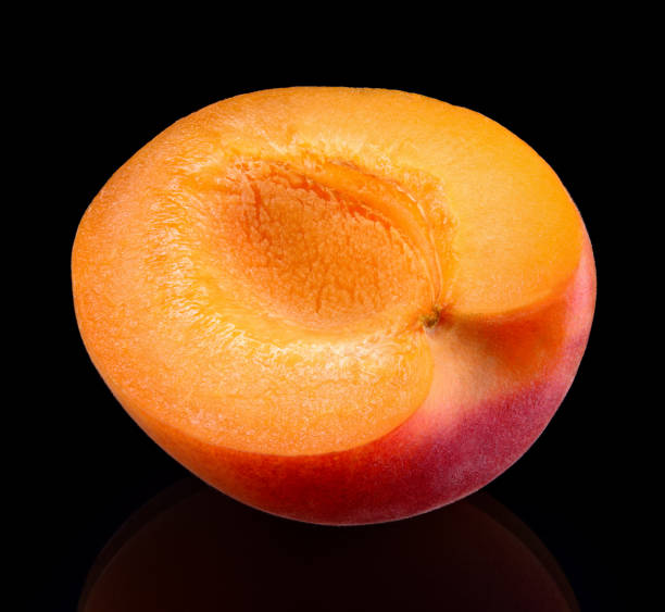 istock Apricot isolate. Apricot on black. Apricot slice, half. Black background. 1231746416