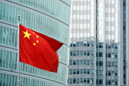Chinese flag against modern buildings