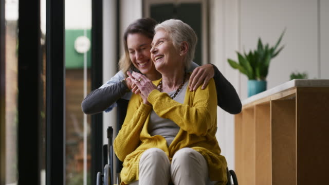 4k video footage of a nurse caring for a senior woman in a wheelchair