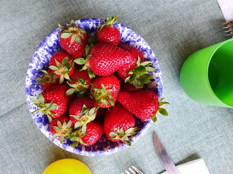 Healthy breakfast with red strawberry on the table with green tablecloth