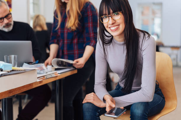 istock Young businesswoman working in a busy office 1231802506