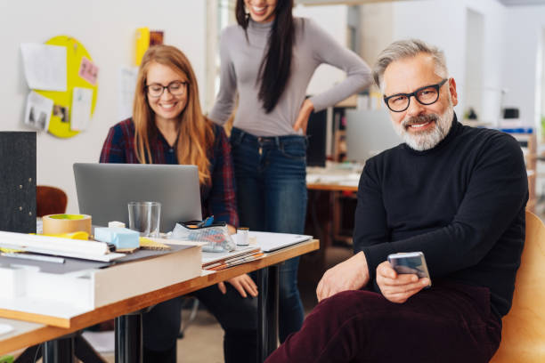 istock Group of co-workers in a busy office 1231808805