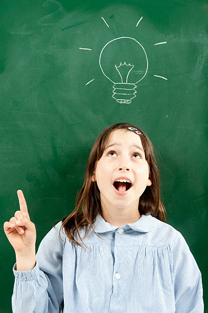 istock girl with blackboard and lightbulb 123181011