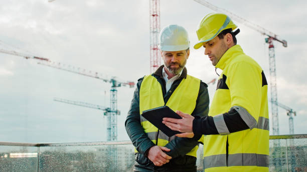 Engineers team using a tablet on construction site stock photo