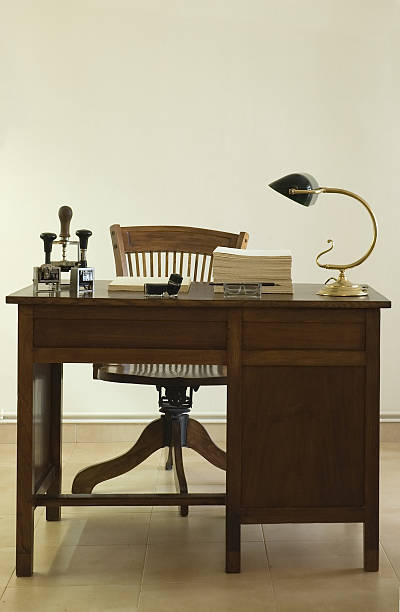 istock Front view of a vintage desk with a lamp and office items 123182272