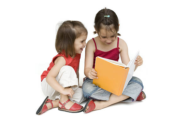 istock little girls reading a book 123182321