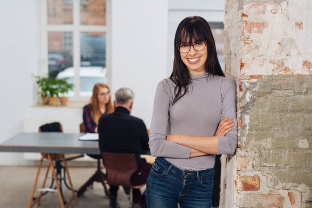 istock Relaxed happy young woman in an office 1231828012