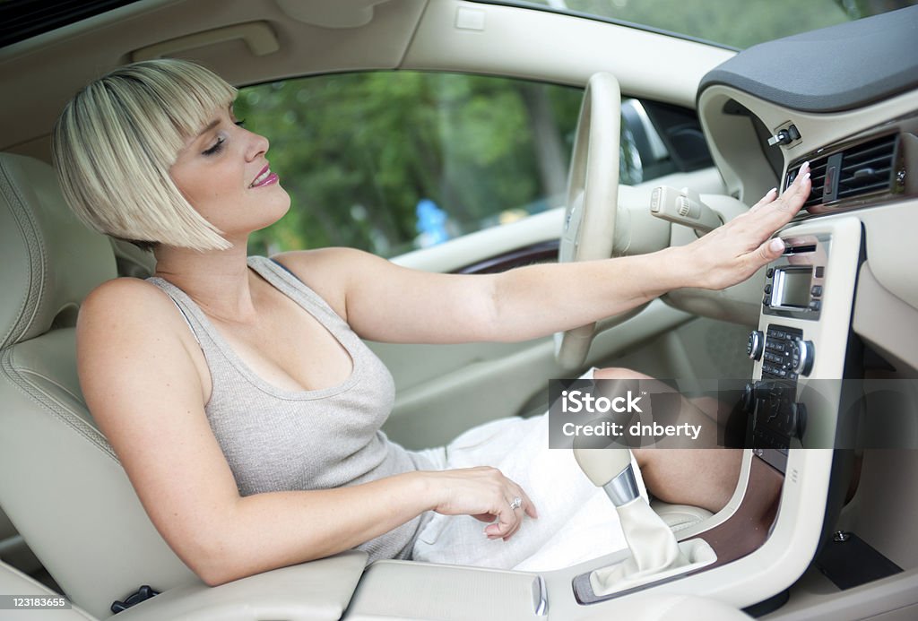 woman cooling in the car woman cooling herself with air conditioner in her car Car Stock Photo