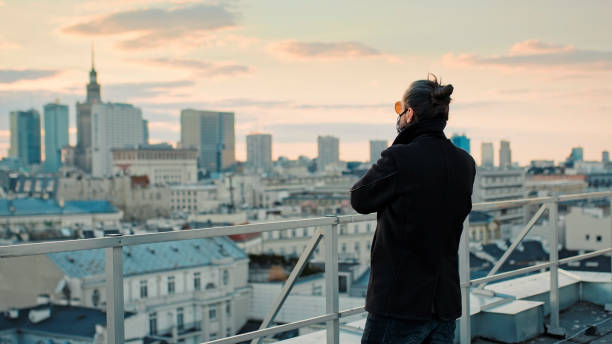 istock Enjoying freedom during pandemic. Rooftop city view 1231845412
