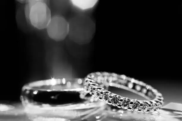 Wedding rings. Inlaid diamonds. Focus on women's wedding ring. Soft focus.