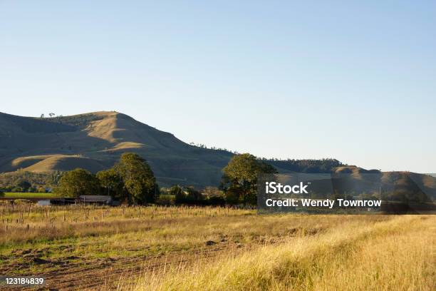 Farm House In Front Of Rolling Hills In Afternoon Shadow Stock Photo - Download Image Now