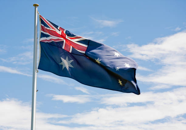 istock Australian Flag fluttering in the wind against a blue sky 123185242