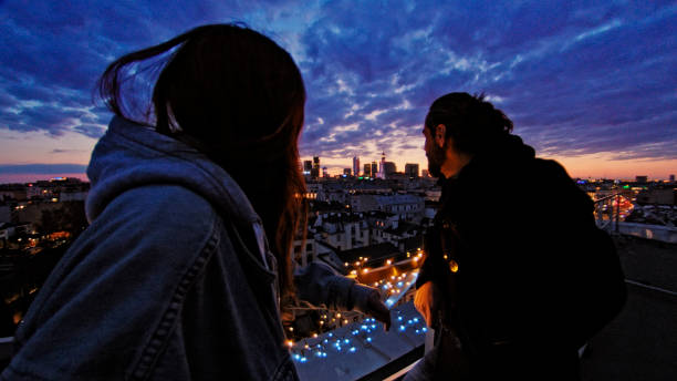 istock Night talks on illuminated rooftop. City after sunset 1231854497