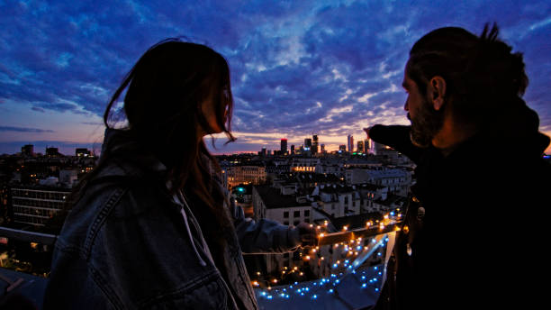 istock Night talks on illuminated rooftop. City after sunset 1231855272