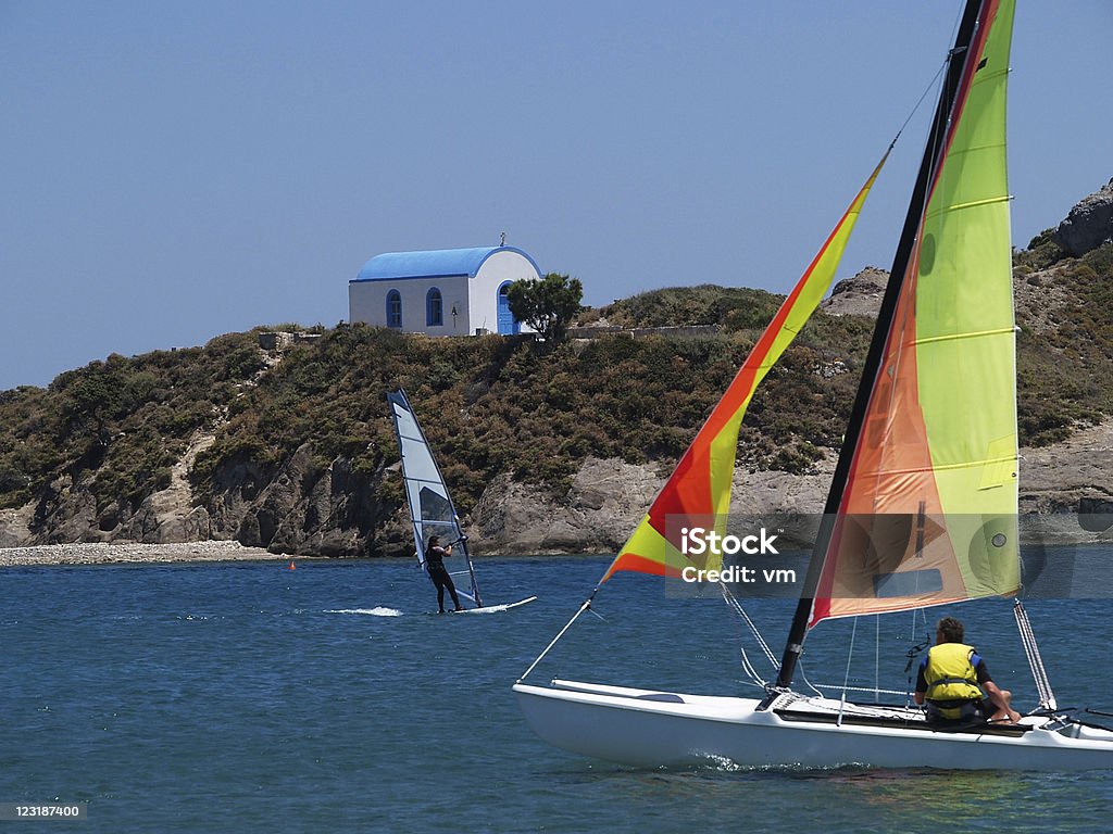 Surfing Greece Windsurfer, sailor and the church on island Kos, Greece. Kos Stock Photo