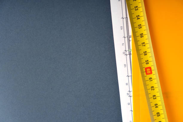 istock Architecture, building design and construction concept with building tape and building drawing in a folder. Background with copy space. 1231875381