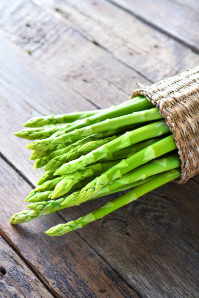 istock Asparagus. Fresh green asparagus vertical background. 1231878484