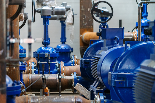 Pipelines, fittings, valves and pumps. Boiler room under construction.