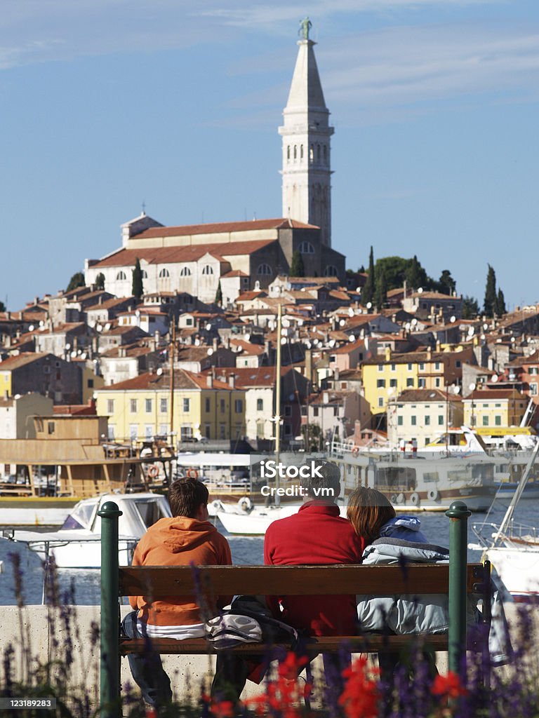 Family sitting on the bench at Rovinj Harbor  Adriatic Sea Stock Photo