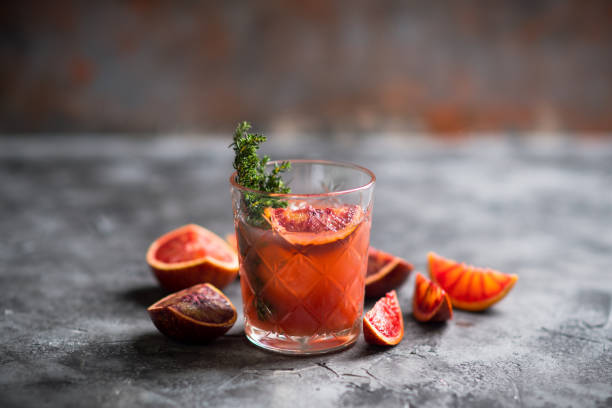 istock Old-fashioned cocktail with blood oranges and thyme on the rustic background 1231893189