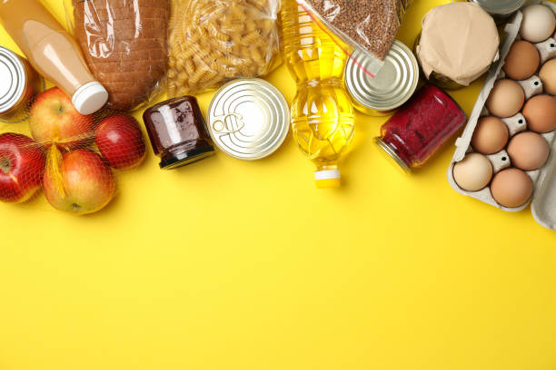 istock Different food on yellow background, top view. Donation concept 1231909672