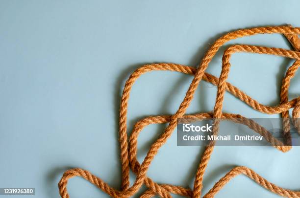 Thin Jute Rope On A Light Blue Background Stock Photo - Download Image Now - Abstract, Backgrounds, Blue