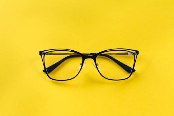 istock transparent glasses for vision with black arms on a bright yellow background. 1231962387