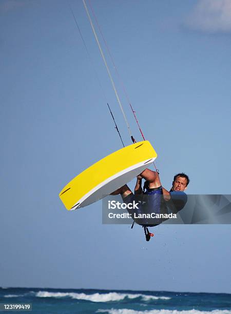 Kitesurfer Makes A Jump Up In The Air Stock Photo - Download Image Now - Kiteboarding, Jumping, Activity