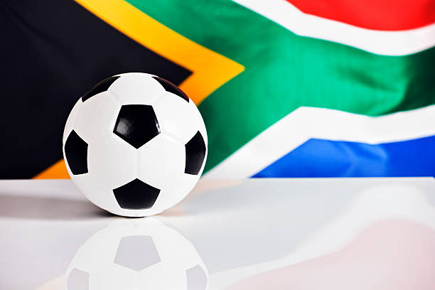 istock Soccer ball sits on shiny surface against South African flag 123201017