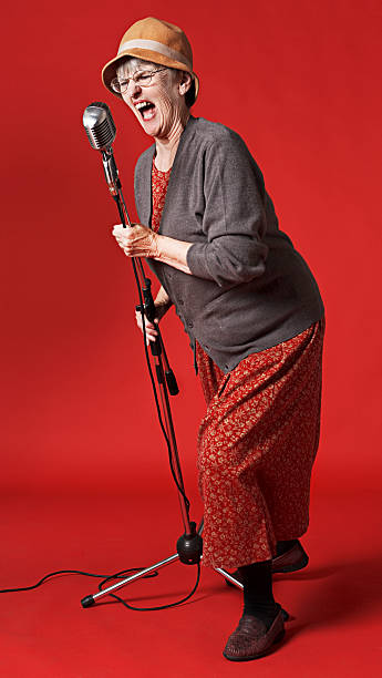 Old lady belts out song into microphone  microphone stand photos stock pictures, royalty-free photos & images