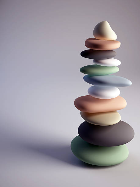 Colorful pebbles stack with sharp one on top stock photo