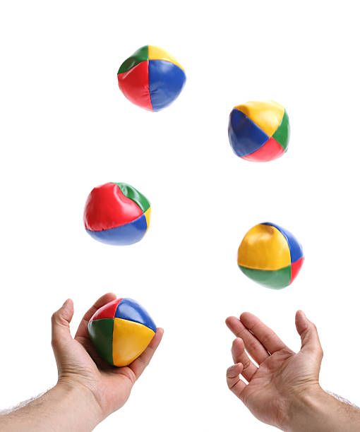 Two hands juggling set of five colorful bean balls Concept for juggling priorities, 5 balls being thrown by pair of hands over white blurred motion on balls juggling stock pictures, royalty-free photos & images