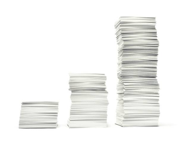 Three stacks of paperwork on white background stock photo