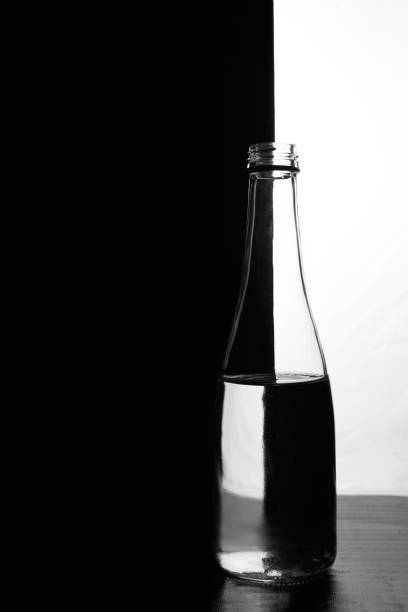 istock A bottle of water on a black and white background. Optical over-reflection effect 1232234608