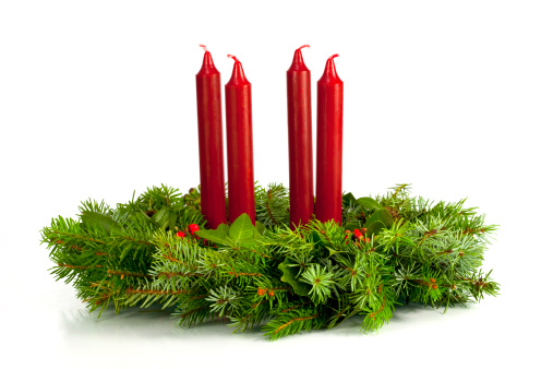 Advent wreath with four white candles, fir branches on wooden background. Sunday December. Traditional diy Christmas decoration, holidays background.