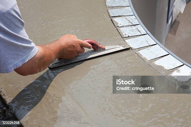 Man Smoothing Over Wet Cement In Swimming Pool Construction Stock Photo - Download Image Now