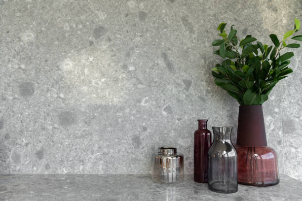 istock Bedroom working corner decorated vase with red ceramic with artificial plant and black glass vase on  gray marble top with  marble wall in the background /apartment interior /copyspace 1232261707