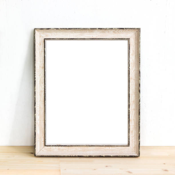 istock Wooden rustic picture frame standing on a table. Product mock up 1232273848