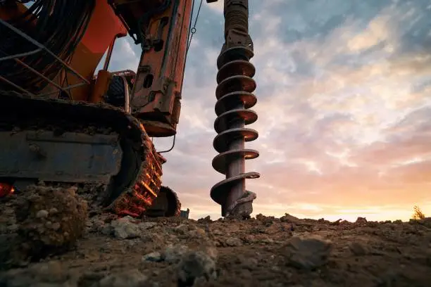 Building activity on contruction site. Close-up view of drilling machine.