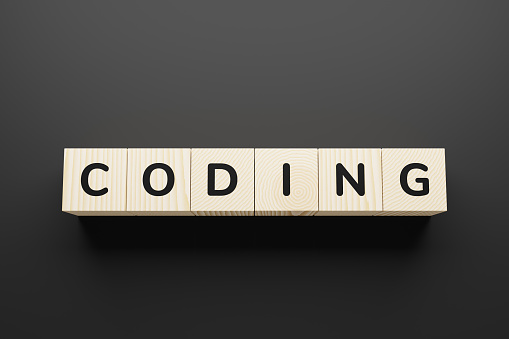 Coding word made with wood building blocks.