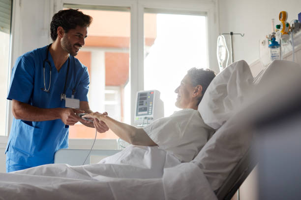 istock Male nurse measuring the pulse with a finger oxymeter 1232305809