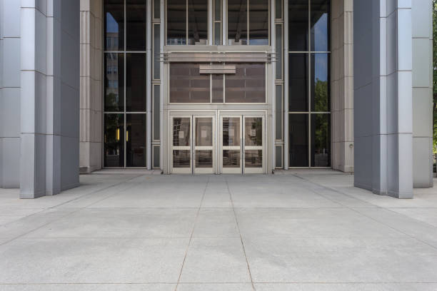 istock Front entrance to a generic office building with modern architecture in a plain urban downtown 1232306829