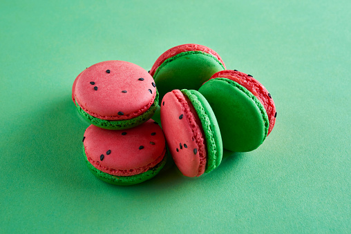 A stack of watermelon flavored French macarons.