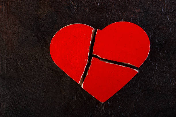 istock Red broken heart against a dark background 1232343970