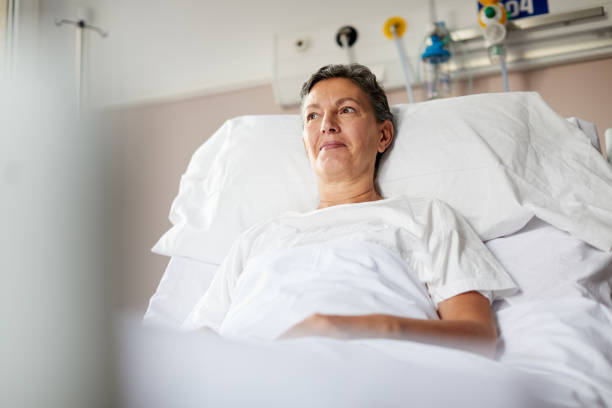 istock One female patient lying down on bed. 1232353365