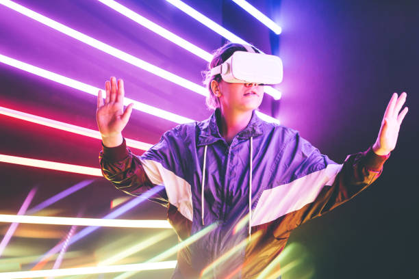Girl using VR goggles in colorful neon lights studio.