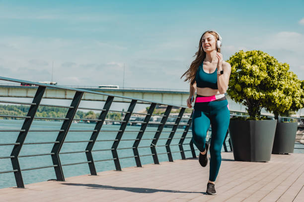 istock Blonde smiling woman running 1232367534